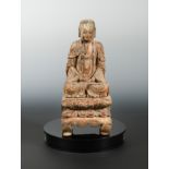 A Chinese carved, polychrome and gilded wood seated figure of a Buddha, perhaps Ming Dynasty,