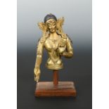 A Tibetan gilt-bronze tara torso fragment, 19th century,