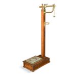 A set of brass and oak weighing scales by W & T Avery Ltd.,
