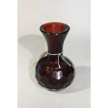 A Chinese Pekin glass dark amber vase with trumpet neck and faceted body,