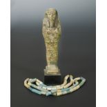 An Egyptian faience shabti figure, impressed with hieroglyphics,