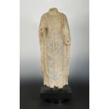 A Chinese grey limestone torso of Buddha standing, Wei Dynasty style,