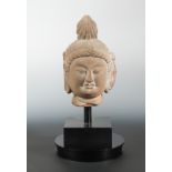 A Chinese red sandstone carved head of Avalokiteshvara, in Song Dynasty style,