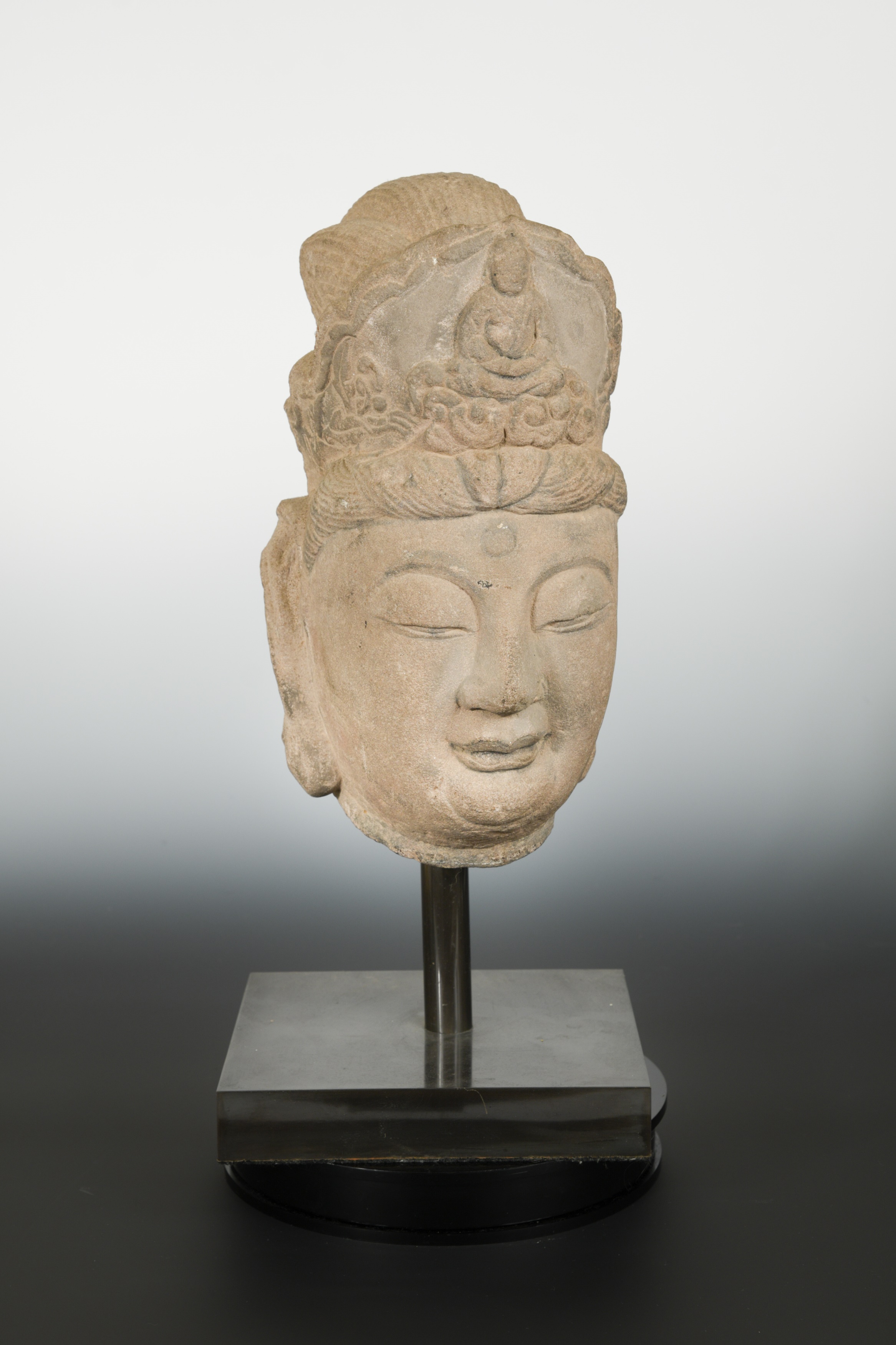 A Chinese sandstone crowned head of Avalokiteshvara, in Tang Dynasty style,