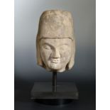 A Chinese cream stone male head, with headdress, perhaps Tang,