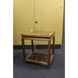 A Chinese hardwood low table/stand, with deeply moulded apron