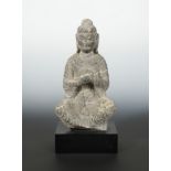 A Chinese white banded grey stone figure of a Seated Buddha, in Wei Dynasty style,