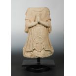 A Chinese carved sandstone robed torso of a Buddhist deity, in Tang Dynasty style,