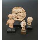 Four Greek pottery fragmentary heads of male and females,