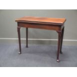 A 19th century mahogany fold over card table on lappet turned supports 76 x 91 x 45cm