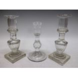 A pair of 19th century glass candlesticks and one 18th century facet candlestick