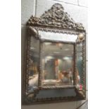 A gilt metal mirror, In Italian Baroque style, the cresting cast with scrolling acanthus and