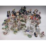A collection of English pottery figurines, to include Staffordshire figures, a creamware model of
