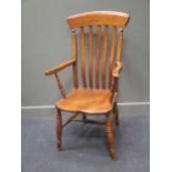 A 19th century elm high back arm chair