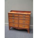 An early 19th century mahogany chest of drawers, with a raised gallery top, over eight drawers on