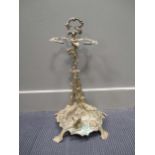 A 19th century brass umbrella stand, the back cast with a gun and a hunting horn, the base with a
