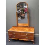 A figured walnut dressing chest of two short and one long drawer on shell carved cabriole feet (