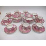 An English porcelain tea service, the pink ground reserved with shaped panels painted with birds,