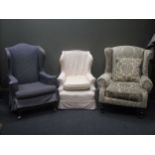 A modern upholstered wing armchair and an early 20th century wing armchair and another small wing