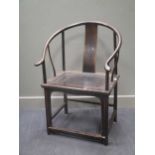 A Chinese hard wood hoop back arm chair
