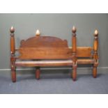 A 19th century walnut single bed with shaped head board and turned supports 129cm wide and 112cm