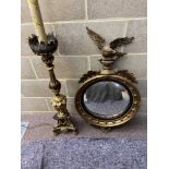 A Regency style gilt convex mirror with eagle cresting, together with a gilt gesso decorated pricket