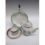 An 18th century English porcelain moulded teapot and associated cover, a Derby cup and saucer and