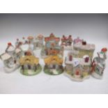 A collection of 13 Victorian and later Staffordshire pastille burner and money boxes in the form