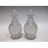 A pair of regency cut glass half size decanters