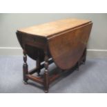 A 17th century oak oval top gateleg dining table with end cutlery drawer,73.5 x 47 x 128 (closed)