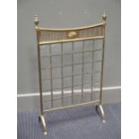 A brass fire screen with urn finials, 83cm high; a cut steel serpentine fender, 123cm wide (2)