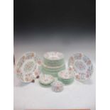 A Minton 'Haddon Hall' pattern service, comprising 24 various cups and 21 various saucers, 2 teapots