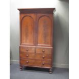 A Victorian mahogany linen press, with a pair of doors above 2 short and 2 long drawers, on turned