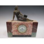 An Art Deco marble mantle clock, surmounted with a reclining female figure