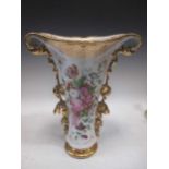 A large Continental 19th century porcelain vase with heavy gilt foliage at the sides enclosing a