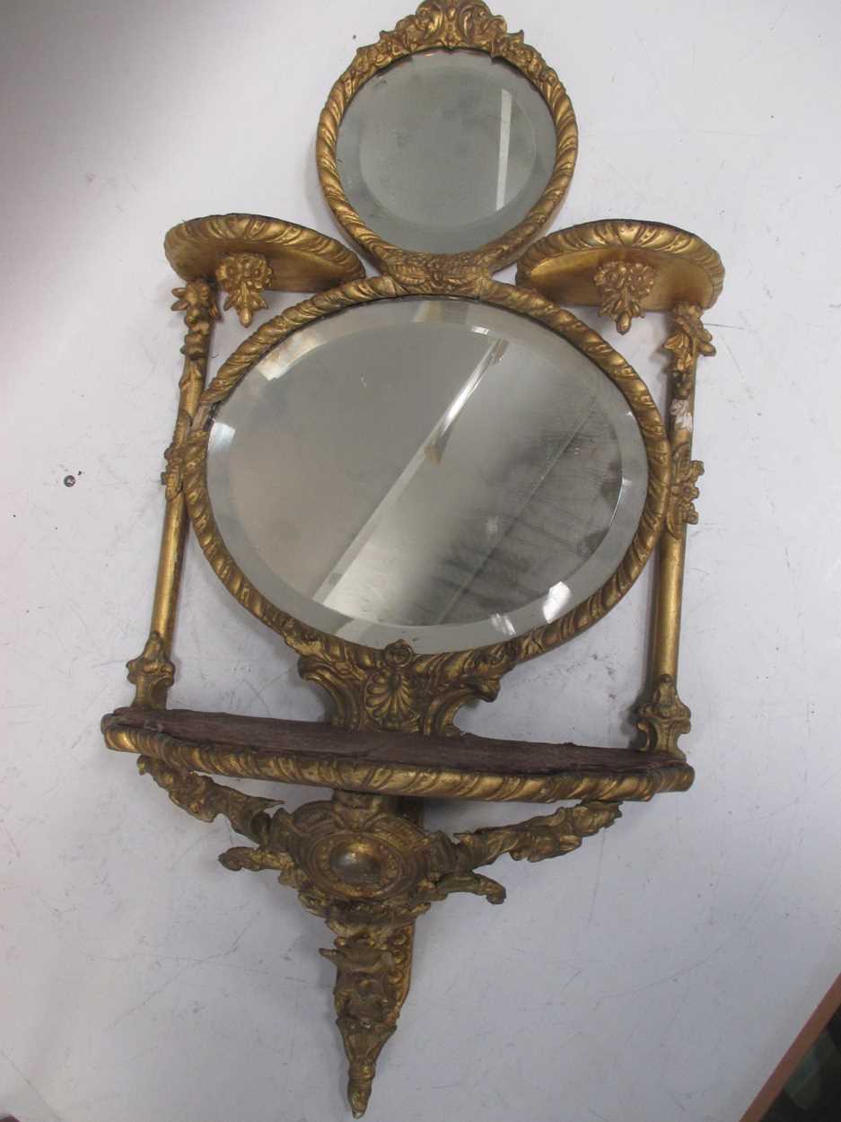 A set of giltwood mirror backed wall shelves, in Louis XVI style, 68cm high