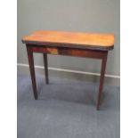 A 19th century mahogany fold over tea table, the rounded rectangular top with reeded edge on