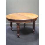 A late Victorian walnut extending dining table, with an extra leaf and a winder 74 x 127 x 124cm (