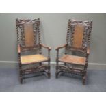A pair of Charles II walnut open arm chairs, the top rail centred with a winged cherub head, caned