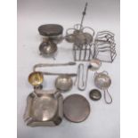 Silver oddments: sugar nips, sifter spoon, tea strainer, cruet frame, 2 toast racks, etc; together