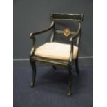 A Regency painted and gilt decorated elbow chair with caned seat