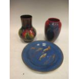 A Royal Doulton 'flambe' vase, 16cm high; a Moorcroft 'Leaf and Berry' pattern vase, 18cm high and a