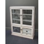 A white painted and glazed cabinet, the interior fitted with a fabric depicting oriental scenes