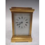 An early 20th century brass carriage clock, 16cm high including handle