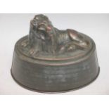 A 19th century copper mould with recumbent lion, 20cm wide