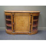 A Victorian walnut and gilt metal mounted Credenza, with central inlaid door, the curved glass
