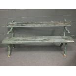 A Victorian cast iron garden bench with timber slats, the ends formed as branches, 172cm wide