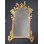 A mahogany Vauxhall type mirror, 63 x 43cm; a giltwood mirror in George II style, with acanthus