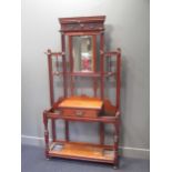 An Aesthetic movement mahogany hall stand, with nine brass hooks, mirror and central drawer 88 x 107