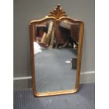 A gilt wall mirror in George I style with shell cresting 86 x 47cm